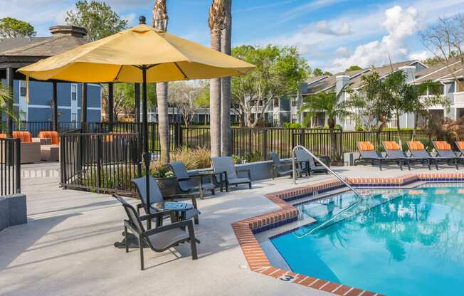 Poolside Seating at Northgreen at Carrollwood Apartments in Tampa, FL