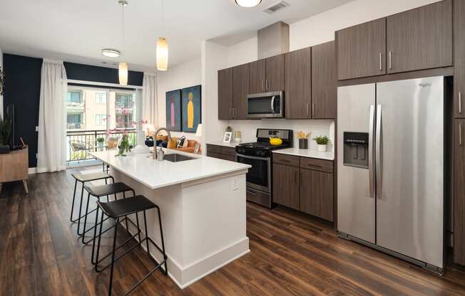 a kitchen with a large island and stainless steel appliances