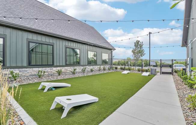 the backyard of a house with a lawn and picnic tables at The Depot Raymore, MO 64083