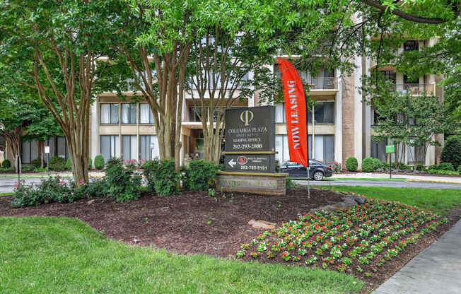 A sign in front of a building that says "Phi" on it.