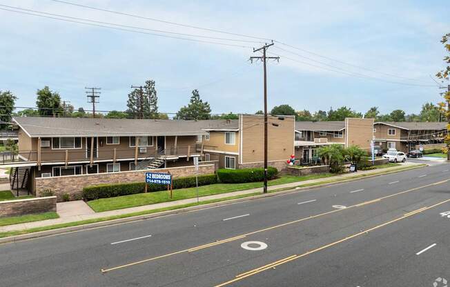 A street view of a residential area with a sign that reads "BROOKHURST".