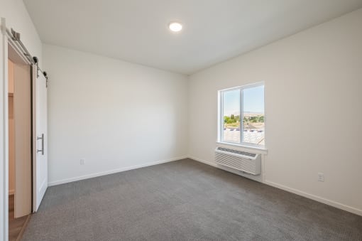 an empty living room with a window and a door at Gateway Apartments, Washington