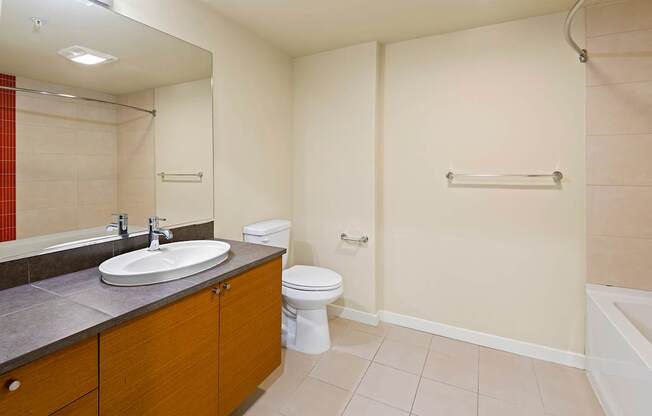 A bathroom with a sink, toilet, and bathtub.
