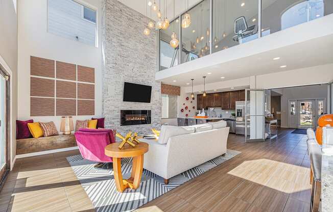 A modern living room with a stone fireplace and a white couch.