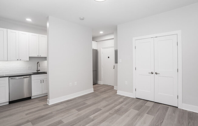 renovated kitchen with white cabinets and stainless steel appliances