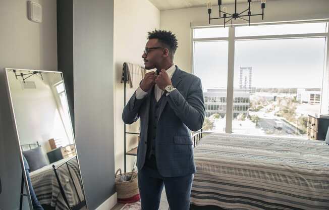 man getting ready for the day in pixon bedroom at Lake Nona Pixon, Orlando, 32827