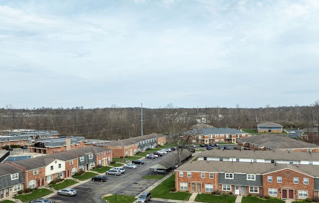 A view of a residential area with houses and cars.