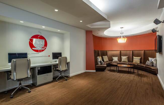 A conference room with a logo on the wall and a couch.