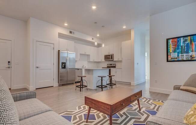 A modern living room with a grey sofa and a wooden coffee table.