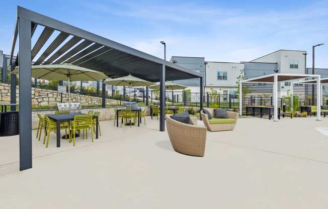 a rendering of a patio with tables and chairs at a building