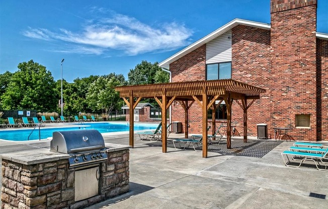 the swimming pool at the resort has a patio with a grill