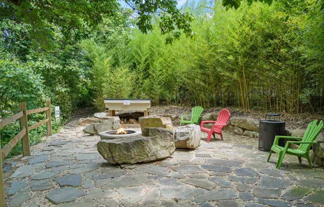 a stone patio with chairs and a fire pit at River Mill Lofts & Skyloft, North Carolina