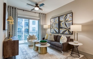a living room with a couch and a ceiling fan at Aura Stonebridge, Richmond, VA 23225