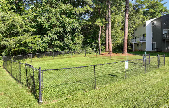 a chain link fence in a yard in front of a apartment building