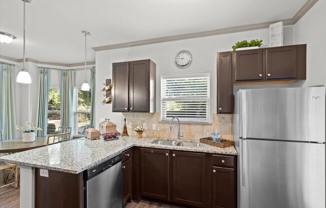 a kitchen with brown cabinets and a granite counter top