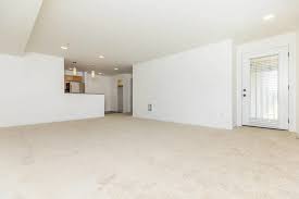 A large empty room with a door on the right side.