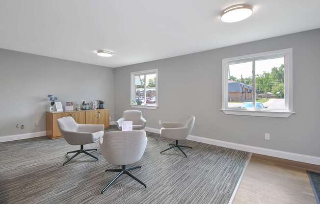 Leasing office lounge with contemporary seating area and welcoming reception at Warren Woods Apartments in Warren, MI.