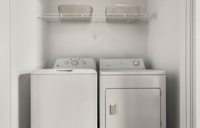 a white washer and dryer in a small laundry room at Veranda at Centerfield, Texas