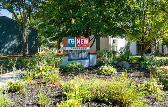 A sign that says "reNEW" is in front of a building.