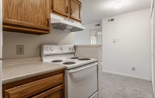 a kitchen with white appliances and wooden cabinets