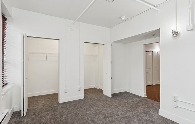A room with white walls and carpeted floor.