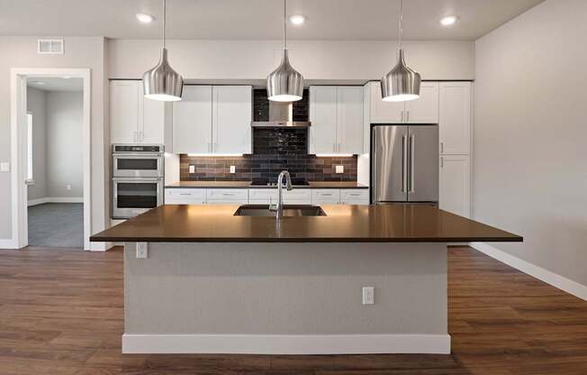 A modern kitchen with a large island in the center.