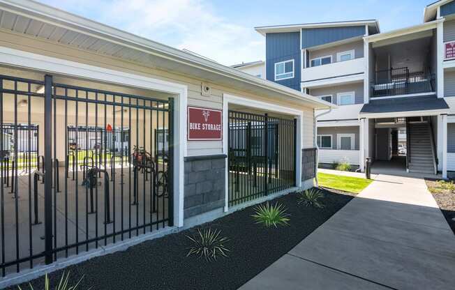 a courtyard with a gate in front of a building with apartments