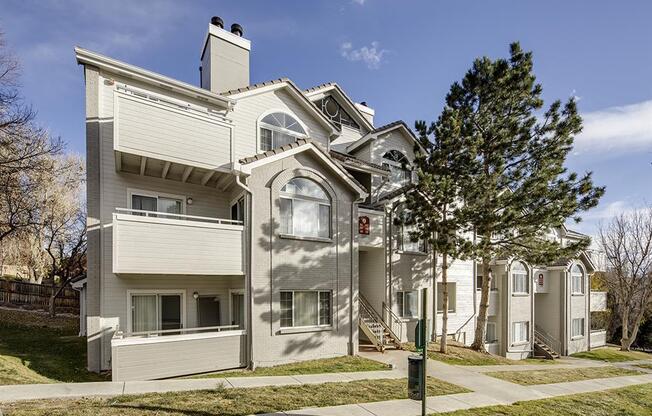 A large, two-story house with a balcony on the second floor.