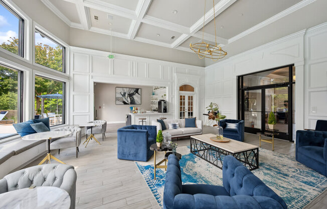 a living room with white walls and a coffered ceiling