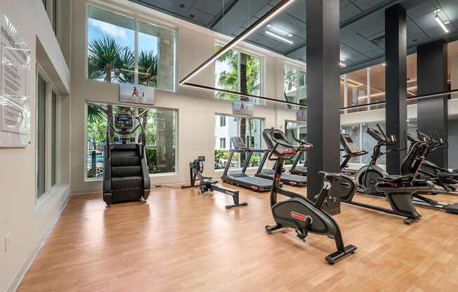 A gym with treadmills, elliptical machines, and a weight machine.