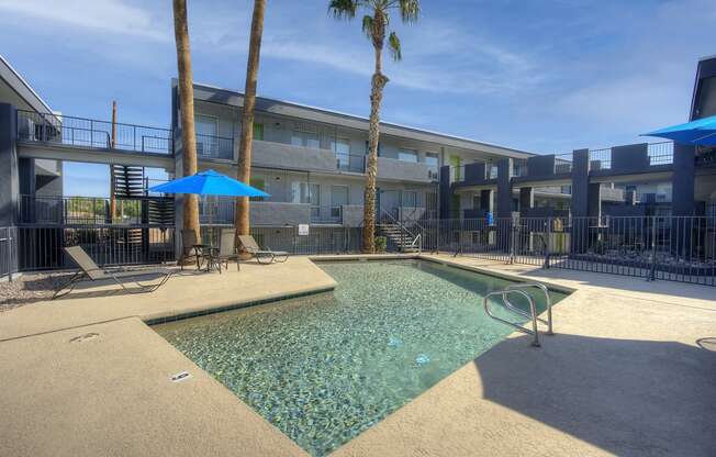 our apartments have a resort style pool with chairs and umbrellas