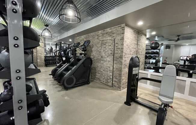 a gym with weights and other exercise equipment on a brick wall at Edge 35, Indianapolis