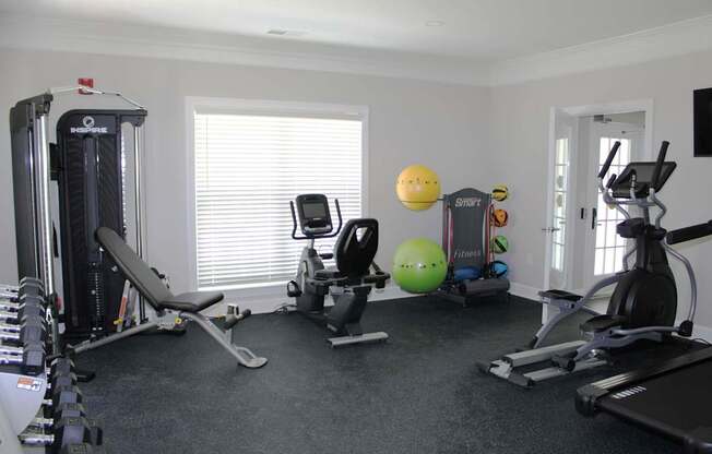 A well-equipped home gym with a variety of exercise equipment.