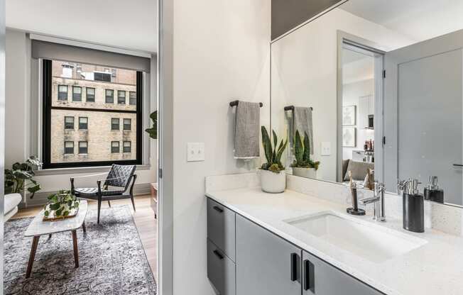 a bathroom with a sink and a mirror and a window at The Commonwealth Building, Pittsburgh