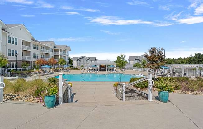 the view of a swimming pool with apartments in the background