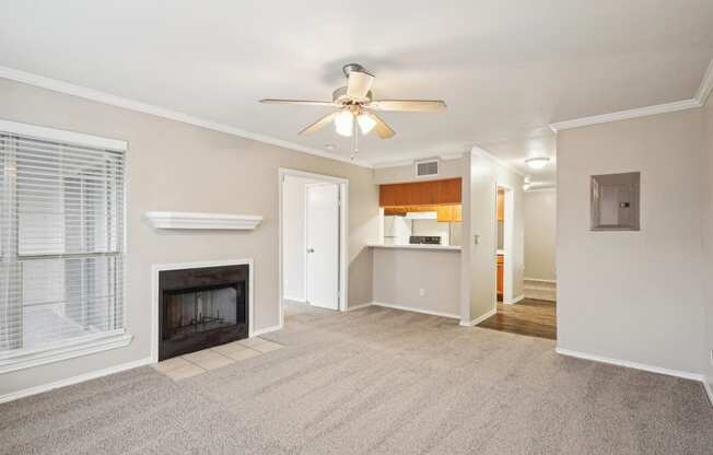 Unfurnished A4 floor plan living room with a fireplace and mantel, ceiling fan, and window Noel on The Parkway in Dallas, TX