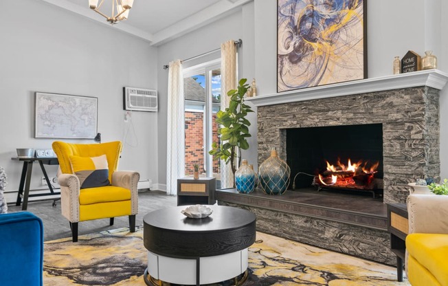 a living room with a fireplace and yellow chairs