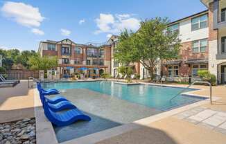 the preserve at ballantyne commons pool with lounge chairs and building with swimming pool