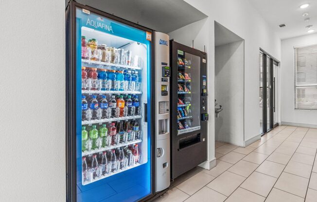 a refrigerator with soda and drinks in a lobby