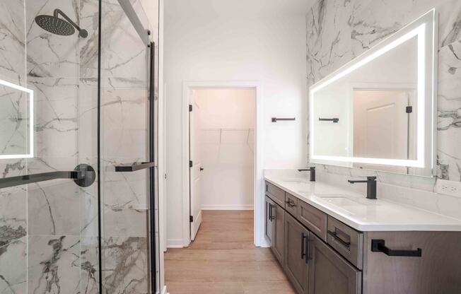 a bathroom with a shower and a sink and a mirror