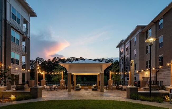 a courtyard with a pavilion in the middle of an apartment building