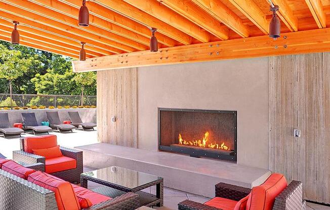 A modern outdoor patio with a fireplace and seating area. at Kirkland Crossing Apartments, Kirkland, WA