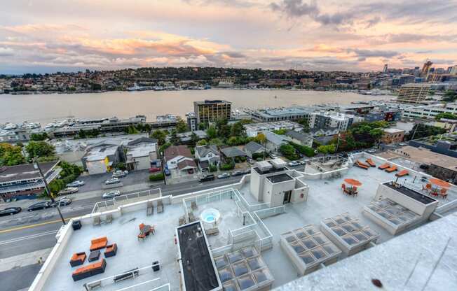 Community Rooftop Lounge Area with View of City, Pink Clouds and Street