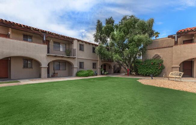 a large lawn in front of a brick building