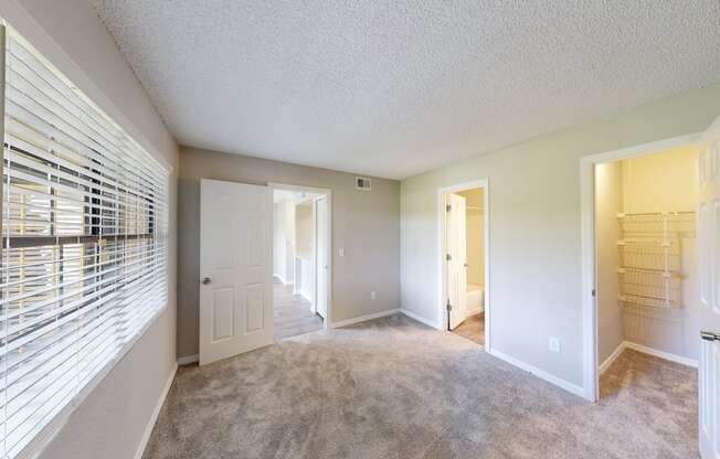 a bedroom with a closet and two doors