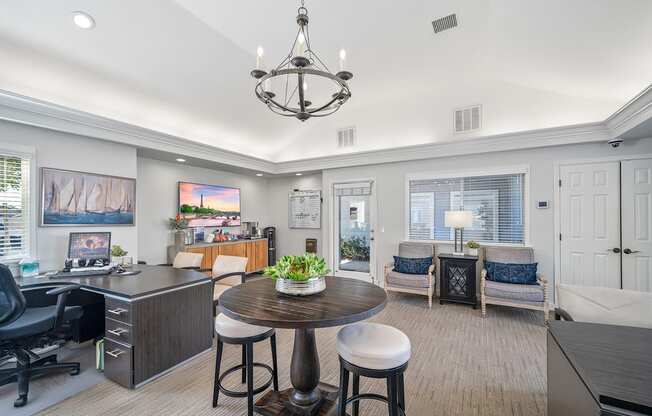 a living room with a kitchen and a dining table