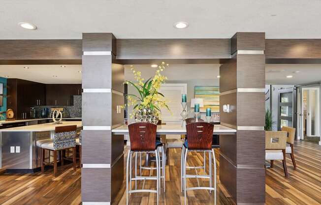 A modern kitchen with a bar area and a dining table set up.