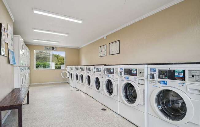 A laundromat with rows of washing machines.