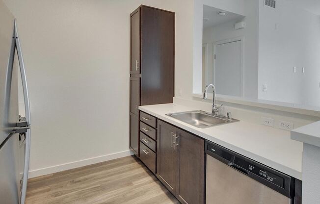 a kitchen with a sink and a refrigerator