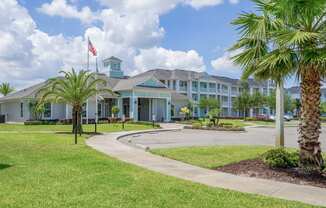 clubhouse with palm trees and a flag in front of it